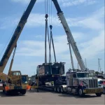 multiple cranes and trucks used for Heavy Hauling