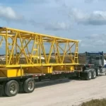 Yellow heavy load on in transport on truck