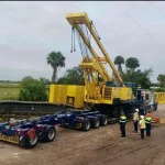 Yellow Crane on heavy transport truck